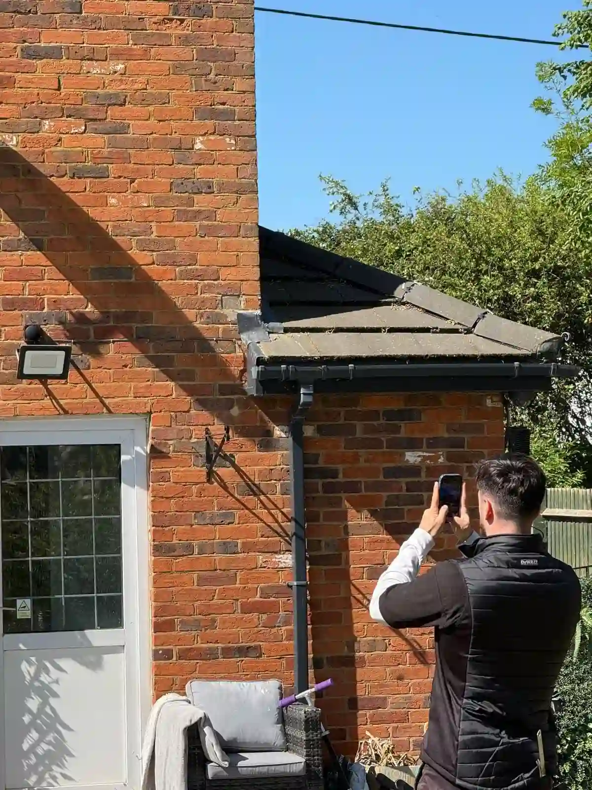 Milton Keynes Homebuyer &Amp; Building Surveys 13 Building surveyor inspecting exterior roof flashing drainage