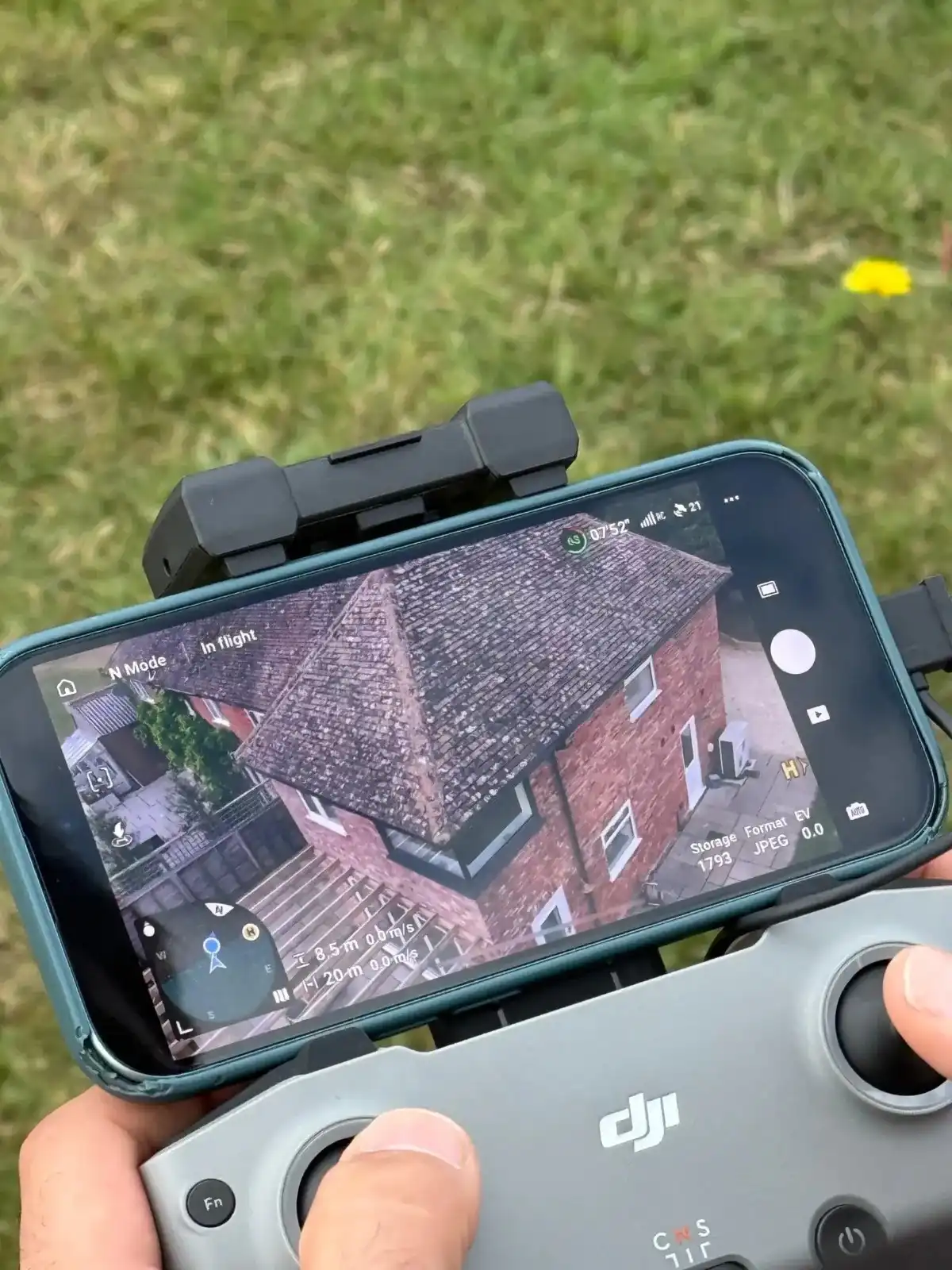 Drone roof inspection view on a smartphone controller during a condition survey, homebuyer survey, or building survey.