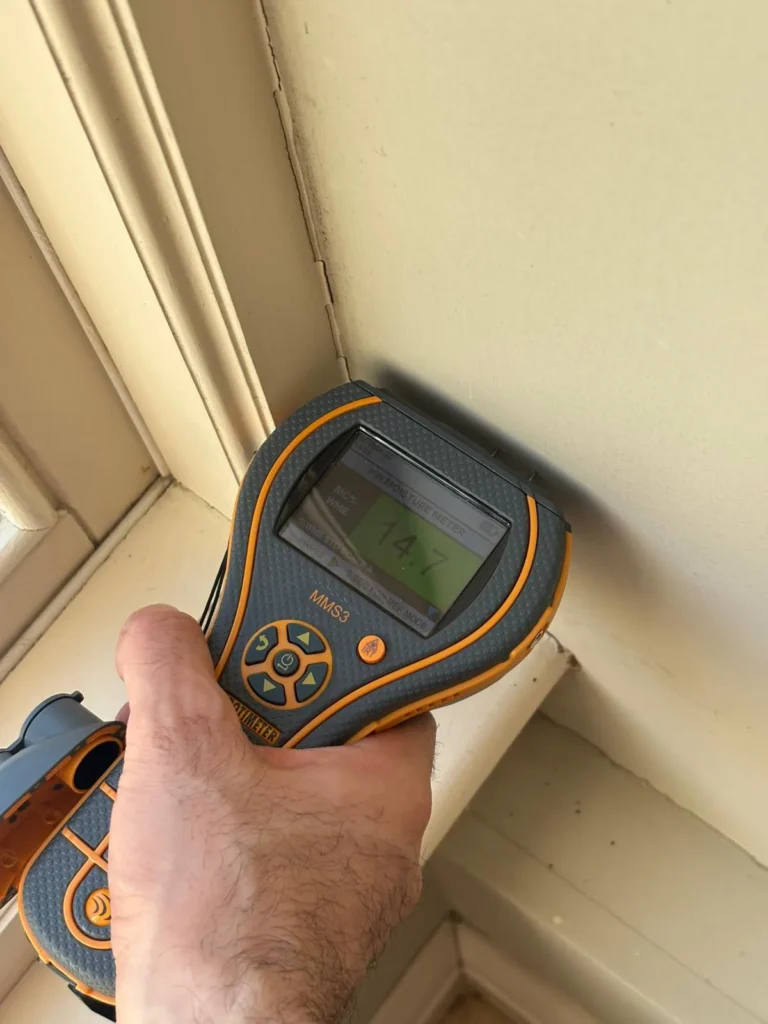 Thermal imaging inspection being conducted on an interior wall to detect heat loss and thermal bridging