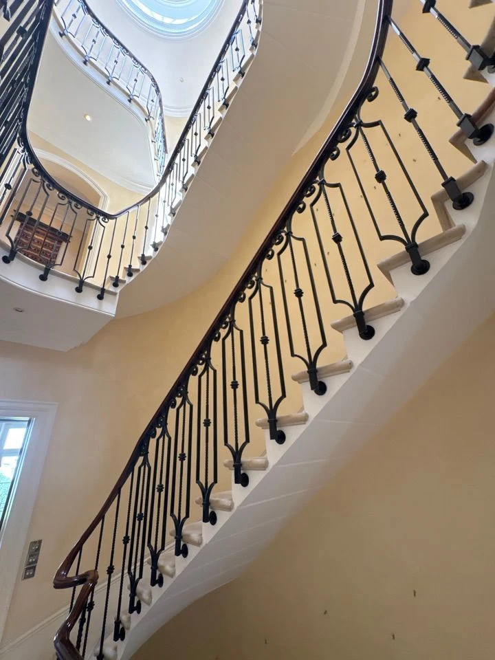 Curved interior staircase with wrought iron balustrade 1