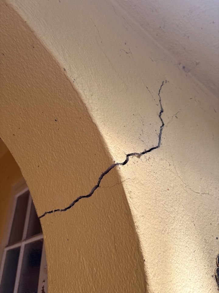 Structural crack on internal archway plaster requiring engineer assessment