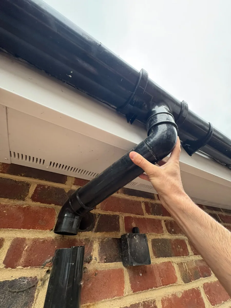 Surveyor checking soffit and guttering on new extension